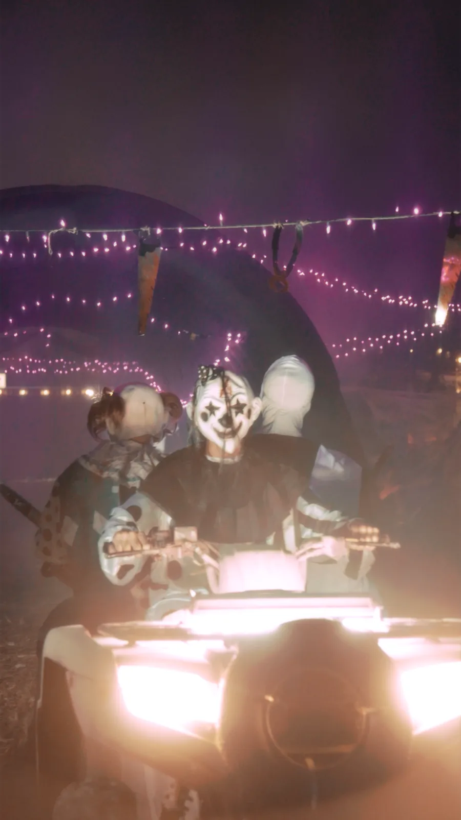 Costumed riders on LED-lit ATVs during a Halloween night glow tour