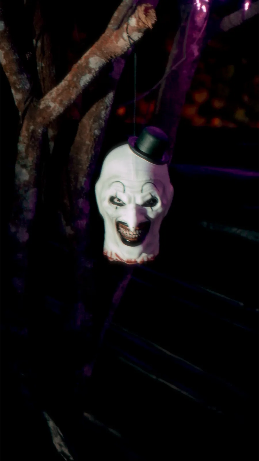 A hanging prop lit against the dark alongside the trail